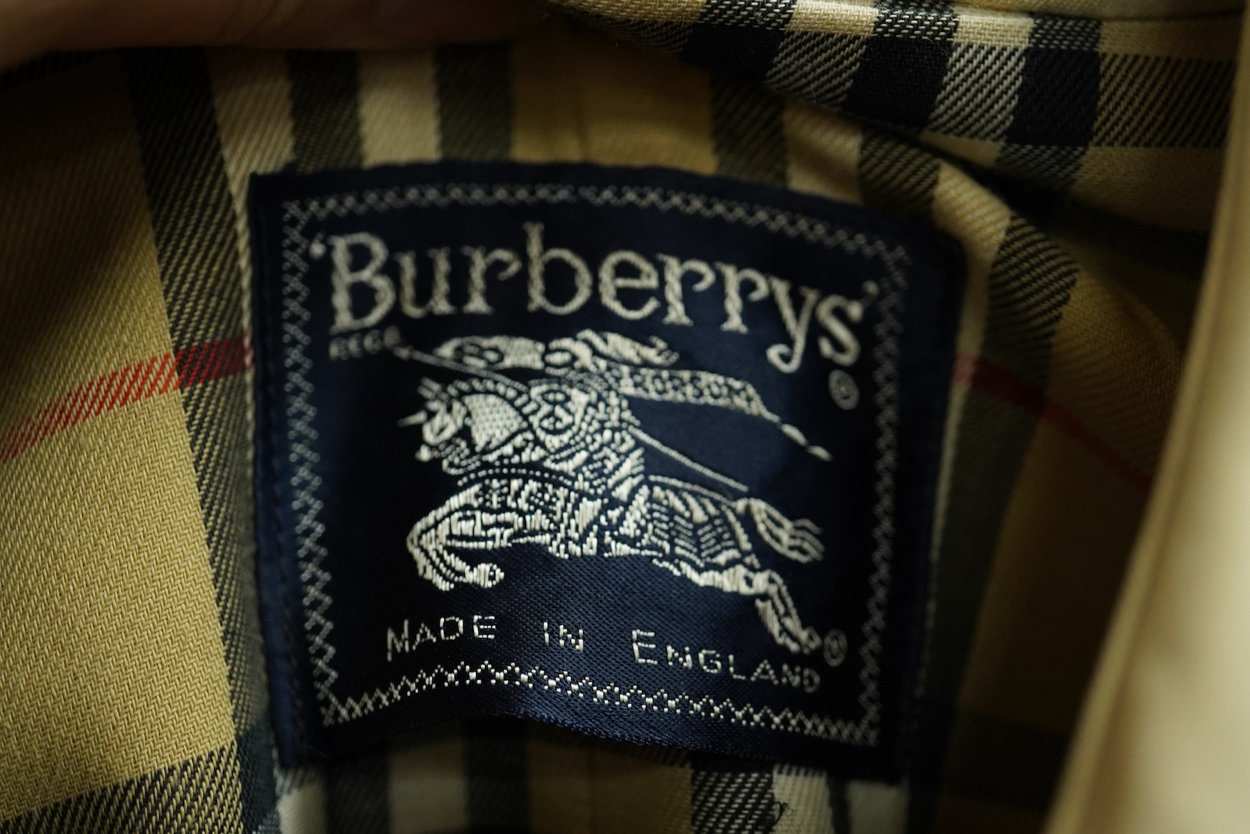 A ladies Burberry mac with check lining and belt, size 16 Long